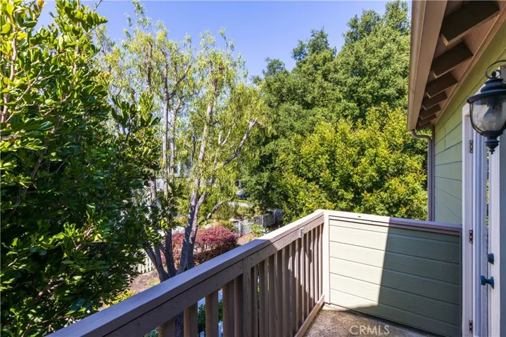 Primary bedroom has a private balcony. Unique to this home is the tall mature trees that surround the home which makes the home very private