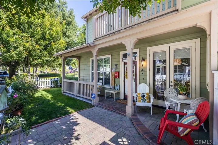 Park like yard with mature trees, rose garden, quaint porch area with lots of seating areas including a porch swing
