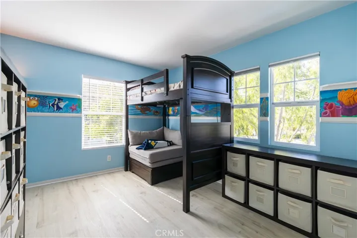 This secondary bedroom has a custom painted mural perfect for a "coastal farmhouse" vibe.