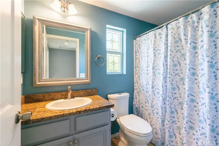 Upstairs secondary bathroom is located on the landing and has leaded glass windows for privacy