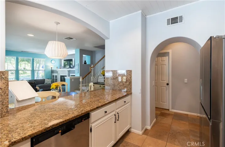 This floorplan creates an entertaining space... arched pass through from kitchen to dining area. Extra counter seating for barstools, lots of windows in living room plus french doors that open to porch.