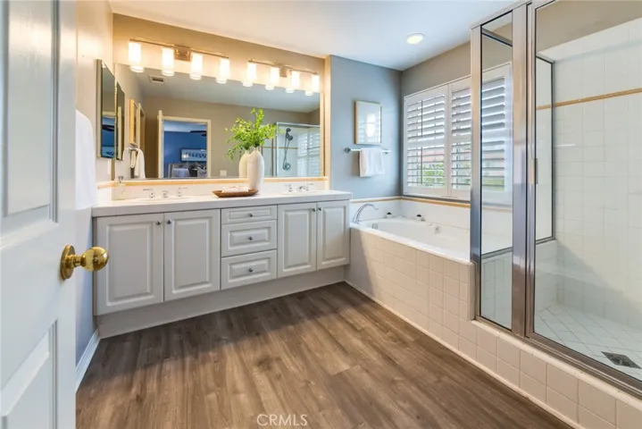Primary Bathroom with Dual Sinks and Separate Tub and Shower