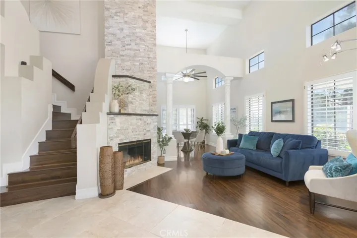Formal living room with a floor-to-ceiling stack stone fireplace as it's focal point