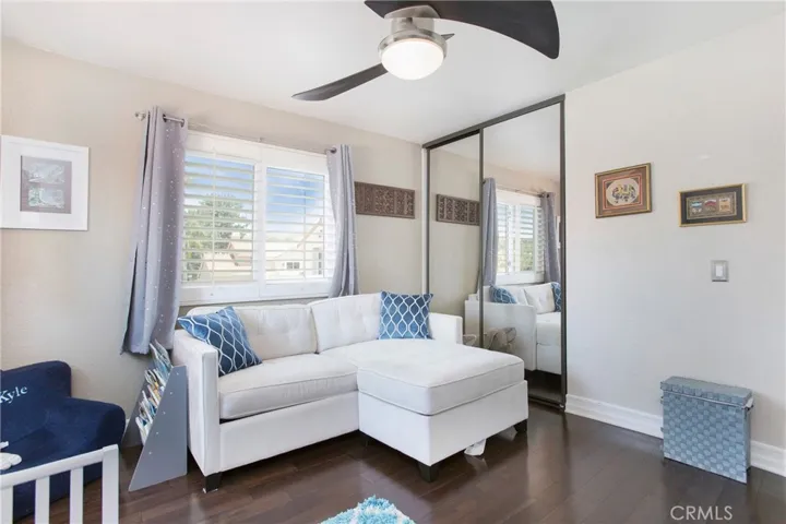 Bedroom 4 with dark walnut engineered wood flooring and a ceiling fan.