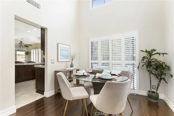Formal dining room off of the kitchen with a view of the pool and manicured gardens