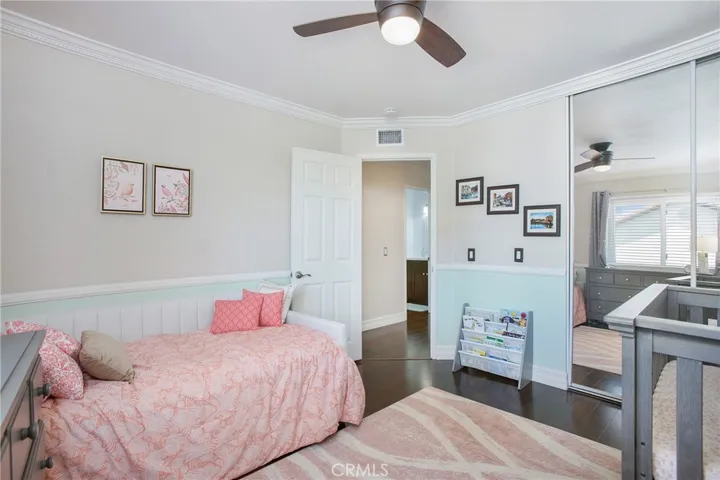Bedroom 3 with dark walnut engineered wood flooring and a ceiling fan.