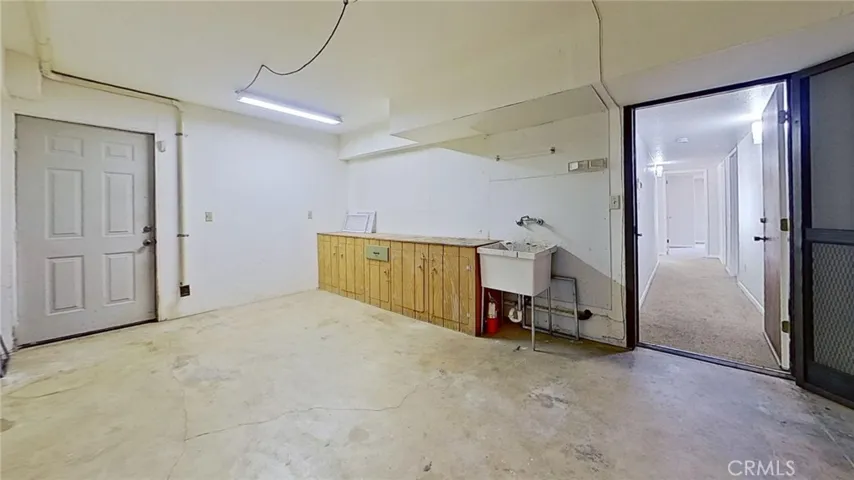 garage area has an exterior door and built-in cabinets