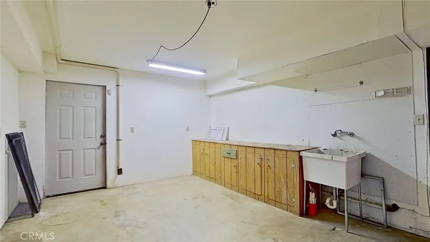 garage area has an exterior door and built-in cabinets