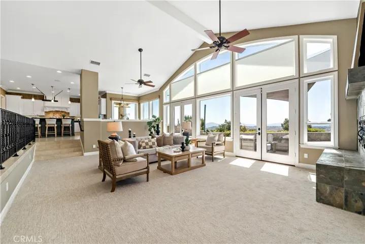 Main living space w floor to ceiling windows to back patio and Temecule wine country