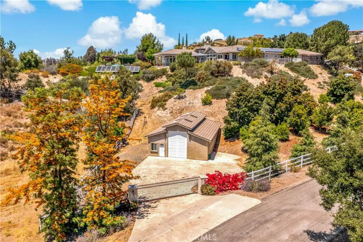 Aerial view of lower portion of property w oversized RV garage w full bathroom and separate gated entrance