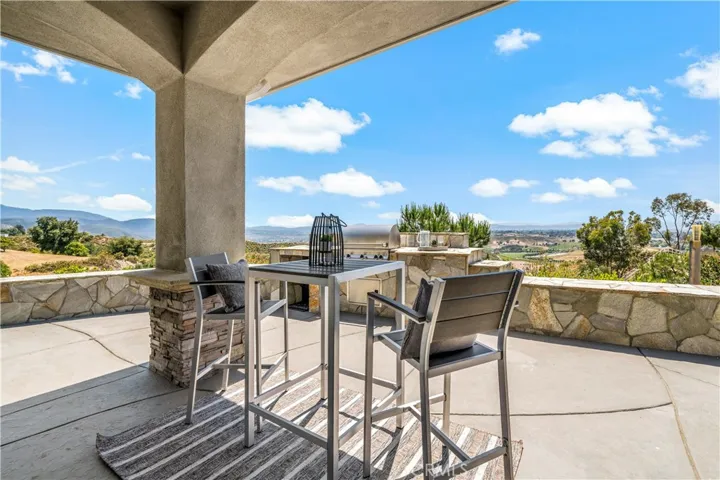Patio area w built in BBQ and views outside the informal dining area