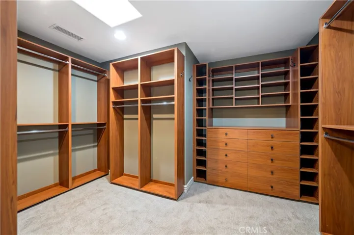 Walk in closet w organizer system off primary bedroom