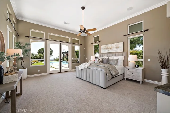 Primary bedroom w french doors leading to pool/spa and 2nd patio area