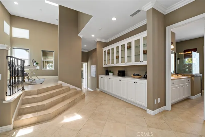 Steps to elevated office w hall bathroom to the right