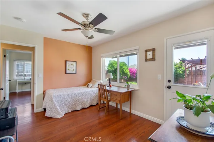 Beautiful 3rd bedroom, including ceiling fan, large window to allow for natural light to flood in and access door to back yard.