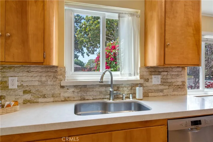 Beautiful well maintained Corian countertop, deep stainless-steel sink, unique rounded off cabinets and window to allow for natural light to flood in.