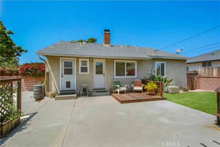 View of back of home including huge paved back area, perfect to set up an outdoor ping pong table.