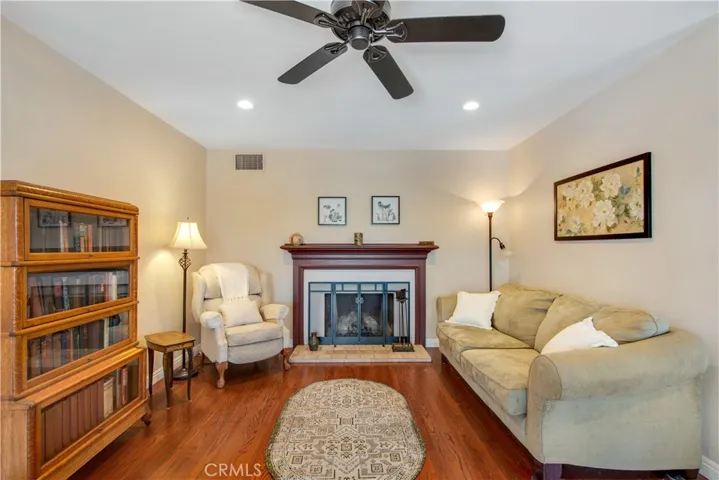 Living room including beautiful fire burning fireplace and mantle.