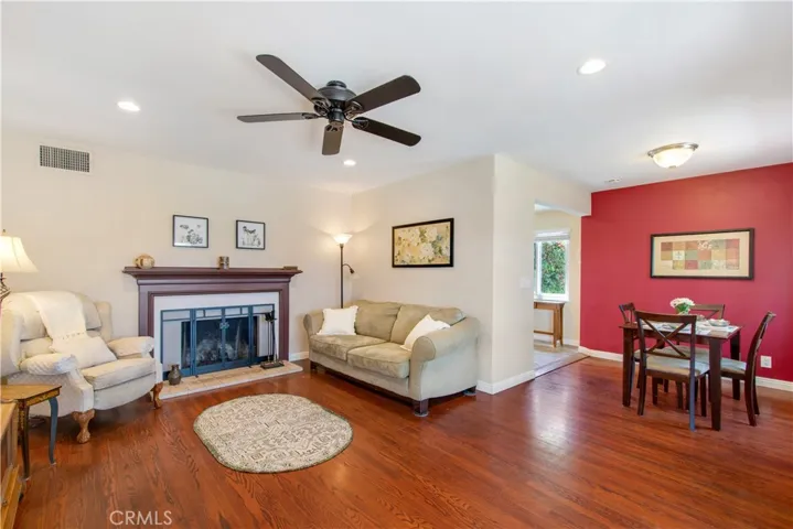 Beautiful wood floors, recessed lighting and ceiling fan and wood burning fireplace to cozy up too on those chilly nights.