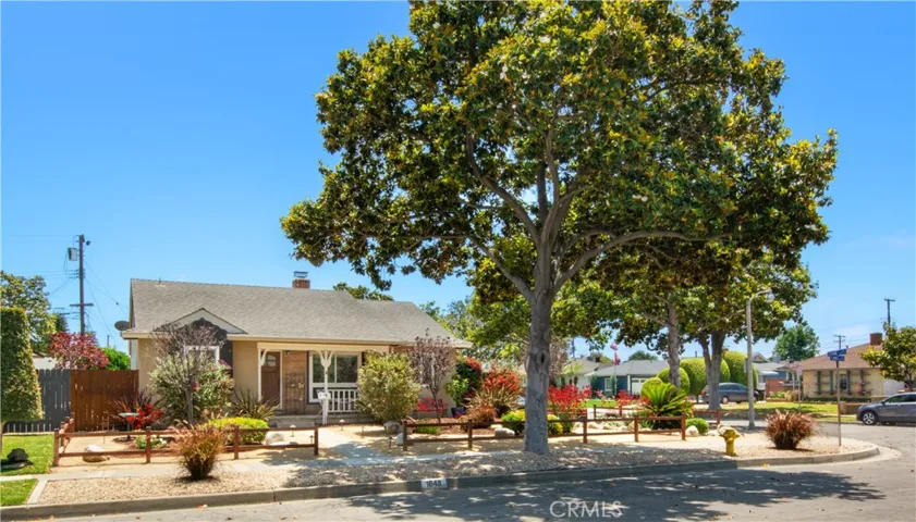 Beautiful view of front of home and front covered patio porch, perfect to sit, relax and wave hello to your neighbors or bask at your amazing dry landscaping which includes decomposed granite, rock and mulch. Also, beautiful mature Magnolia tree, butterfly bush, paw-paws and Pago palm to name a few.