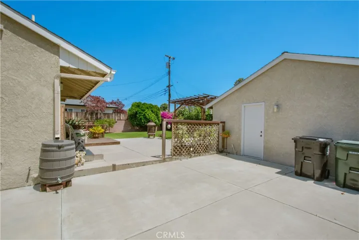 View of back yard from side of home included entry to your 2 car garage.