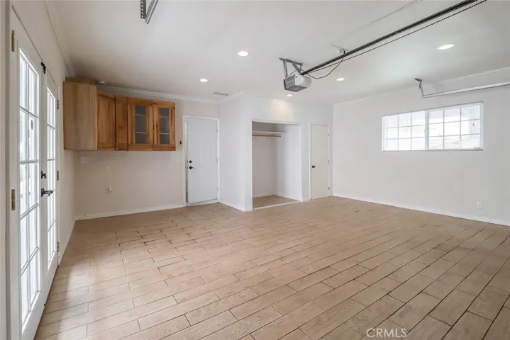 Garage has built in cabinets and french doors to backyard