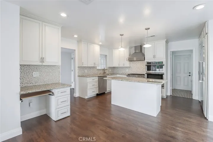 Kitchen has built in desk and walk in pantry