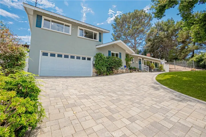 Beautiful house sits high on the hill showcasing city/mountain views.