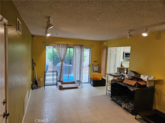 This is the living room with the garage door on the left and the kitchen on the right.