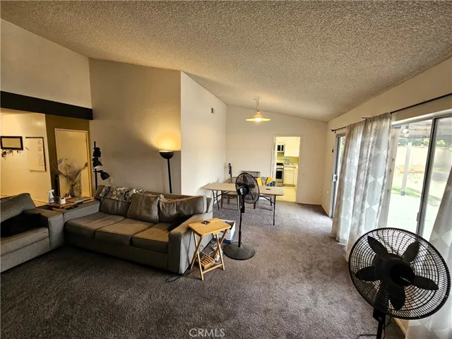 This is the family room (with a fireplace that you can't see in the photo) and the dining room with the kitchen at the far end of the photo.