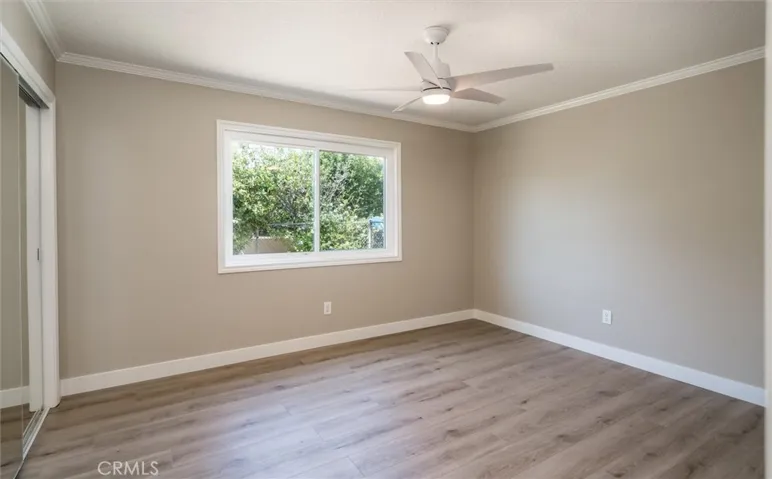 Bedroom #2 with new paint, flooring and ceiling fan.