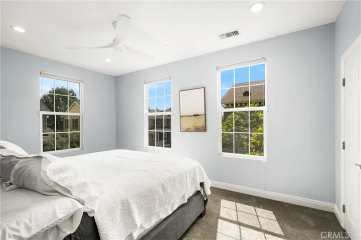 Primary bedroom , upgraded ceiling fan ,recessed lights,  2 closets, tons of natural light.