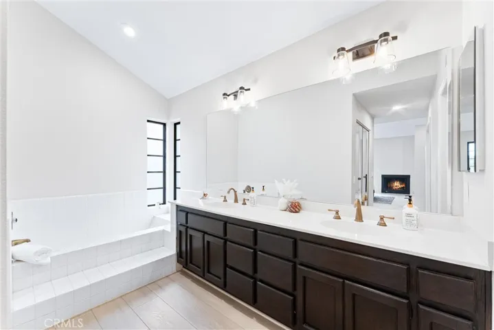 Primary bath with a soaking tub plus a shower just beyond the double vanity