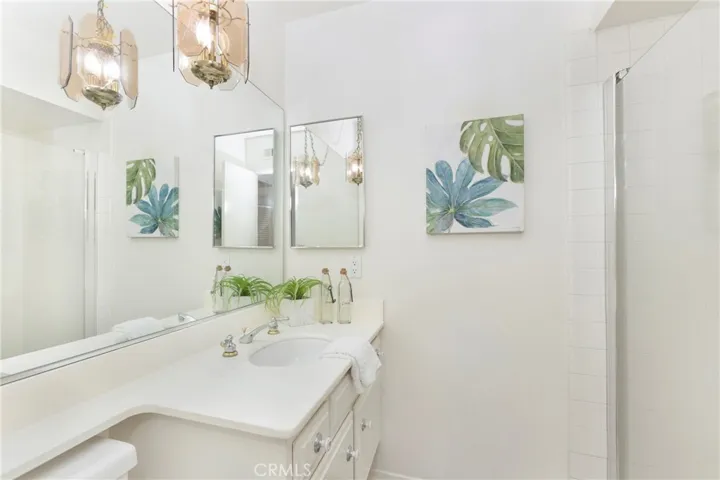 downstairs bath with shower across from down bedroom