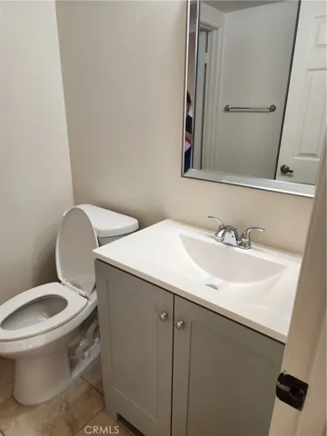 Downstair bath is remodeled with  new vanity, beautiful beveled mirror and high efficiency toilet