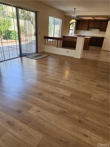 New beautiful laminate flooring open adjacent to kitchen.