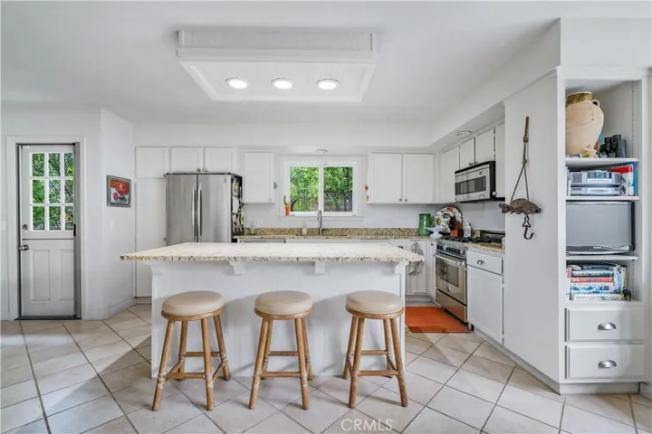 Island provides extra space for food prep as well as for sitting