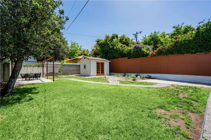 Backyard with custom storage shed and an outdoor deck