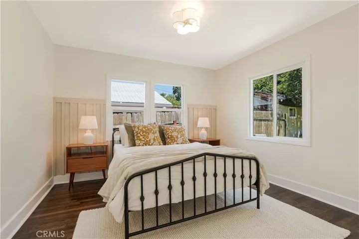 Bedroom 1 with hardwood floors and extra large windows