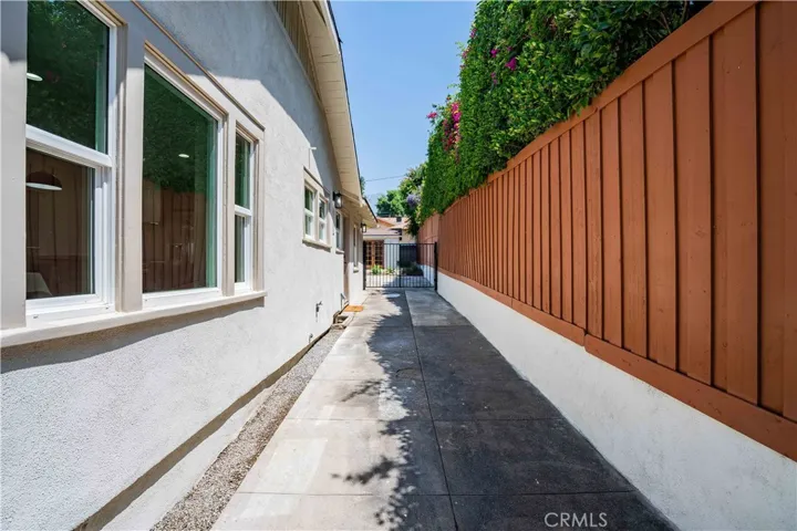Long driveway with wrought iron gate