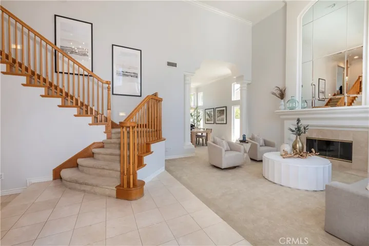 Entering to a Spacious  Living Room with Two Story High Ceiling and Elegant Fire Place