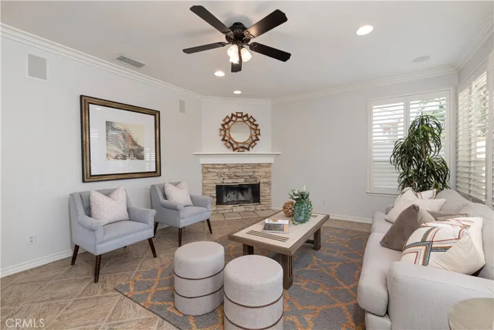 Spacious Family Room with Lighted Fan Celling Fan Celing, Stone Fire Place & Wood Shutters