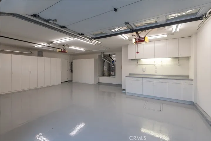 3 Car Garage with Built-in Cabinets and Epoxy Flooring