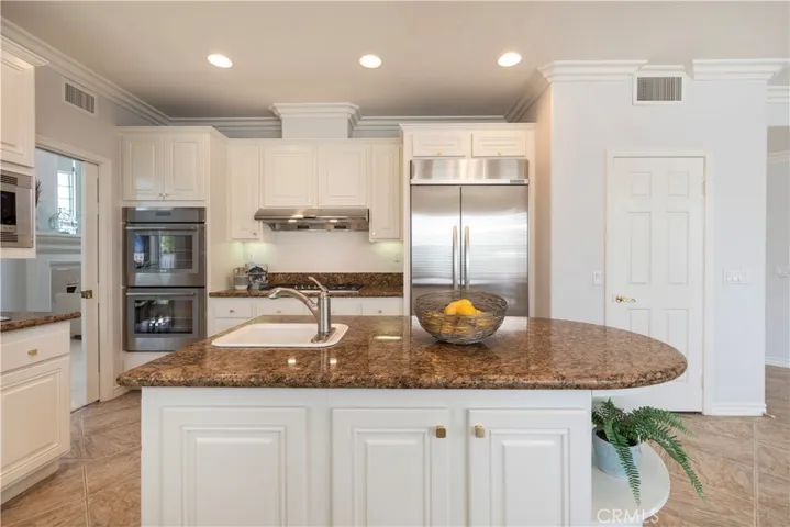Large Island with Vegetable Sink, built-in Refrigerator, Double Oven, Recessed Lighting and Walk in Pantry