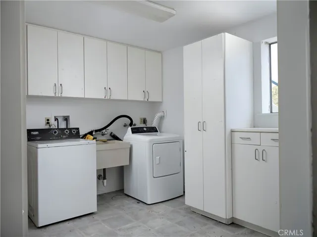 The adjoining Laundry room was plumbed for a toilet at one time and features both Gas and 220V for Dryer hookups...
