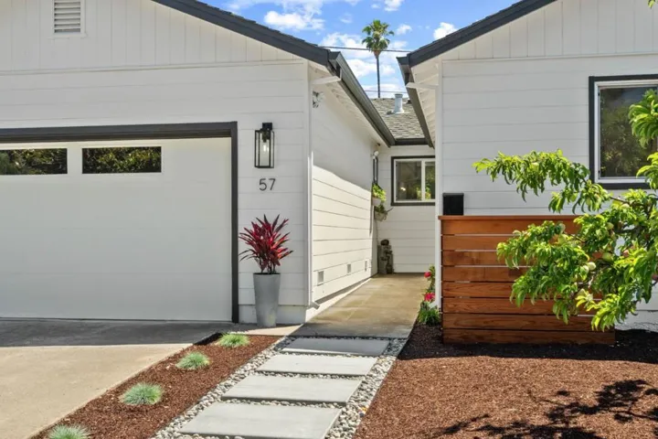 Walkway to front entrance of home with water fountain