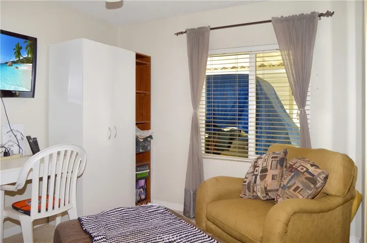 The 2nd bedroom is across from the main bedroom and offers a ceiling fan and mirrored wardrobe doors