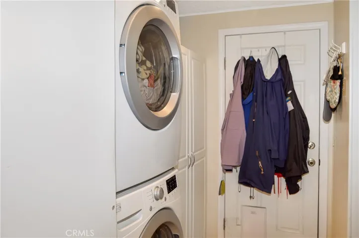 Stackable washer and dryer are included & created added space in the laundry room which has a door to the carport