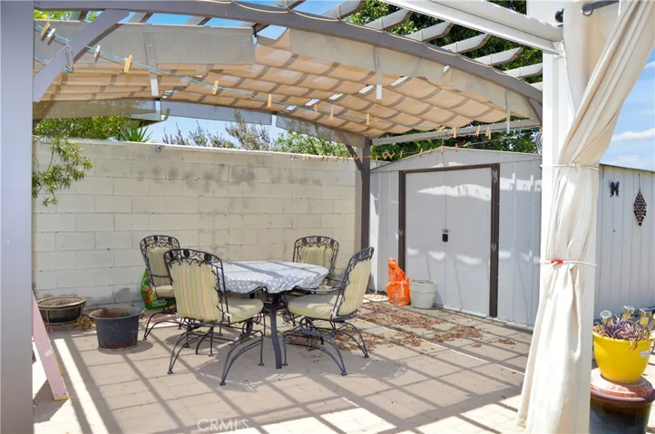 Smaller patio area with door to the larger shed
