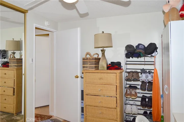 The 2nd bedroom is across from the main bedroom and offers a ceiling fan and mirrored wardrobe doors